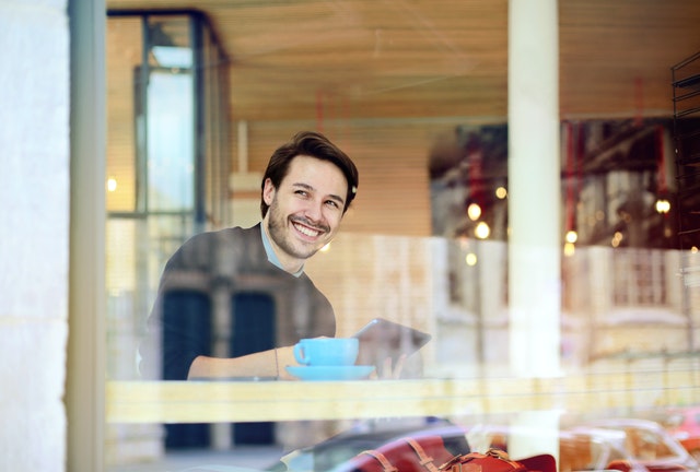 Smiling man looking out window